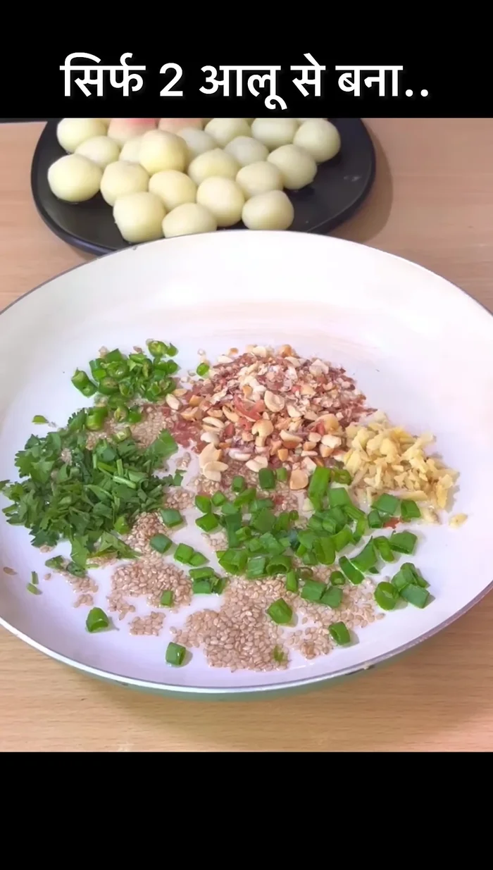 Add crushed ginger and garlic, green chilies, coriander leaves, green onion leaves, chili flakes, and soy sauce. Stir well.