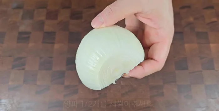 Prepare the sweet onion by slicing it in half.
