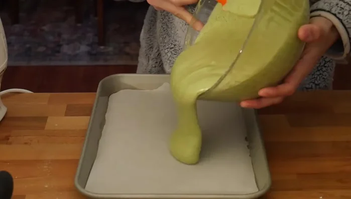 Pour batter into a greased and parchment-lined 9x13 inch jelly roll pan. Tap to remove air bubbles.