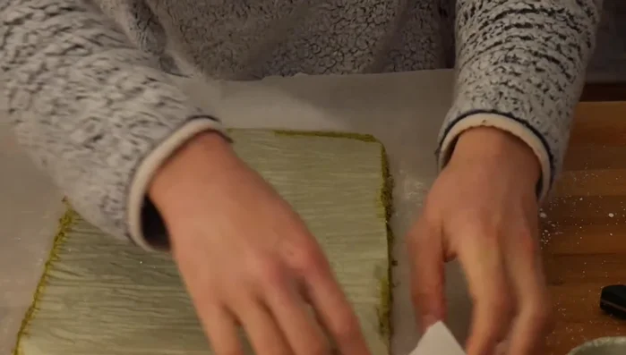 Flip the cake onto a parchment-lined surface, remove the pan and parchment paper. Dust generously with powdered sugar.