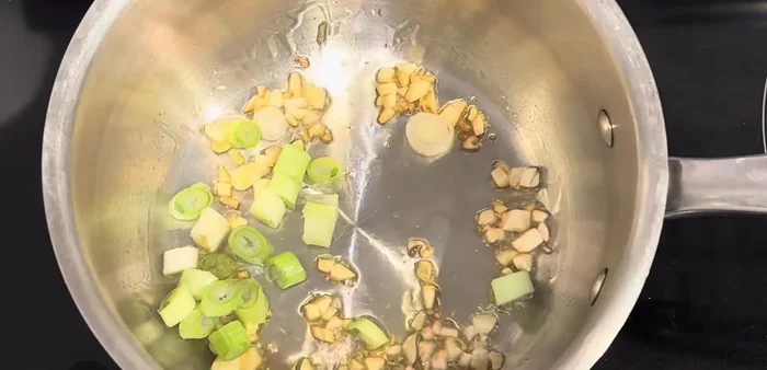 Heat oil in a pot. Add chopped onions and sauté until softened.