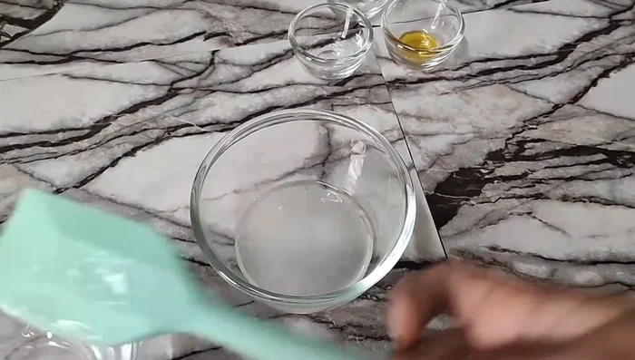 Add the water phase to the oil phase and blend thoroughly until well combined.