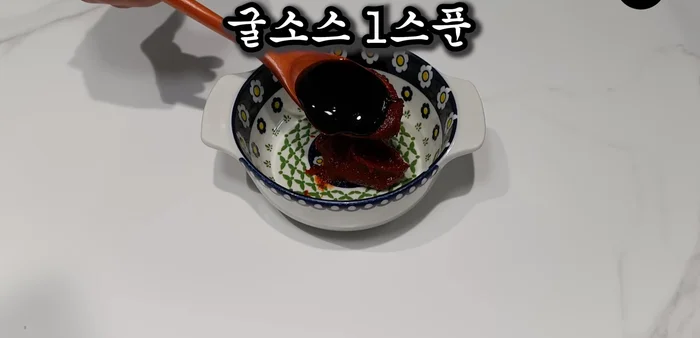 Add gochujang, oyster sauce, sugar, red pepper powder, garlic, chicken broth, and pepper. Mix well.