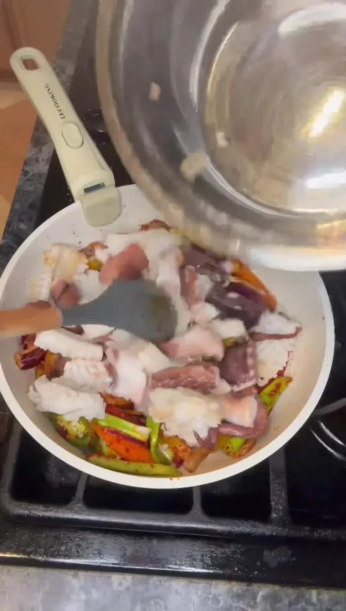 Add the squid to the pan and continue stir-frying until cooked through. The vegetables will release liquid as they cook.