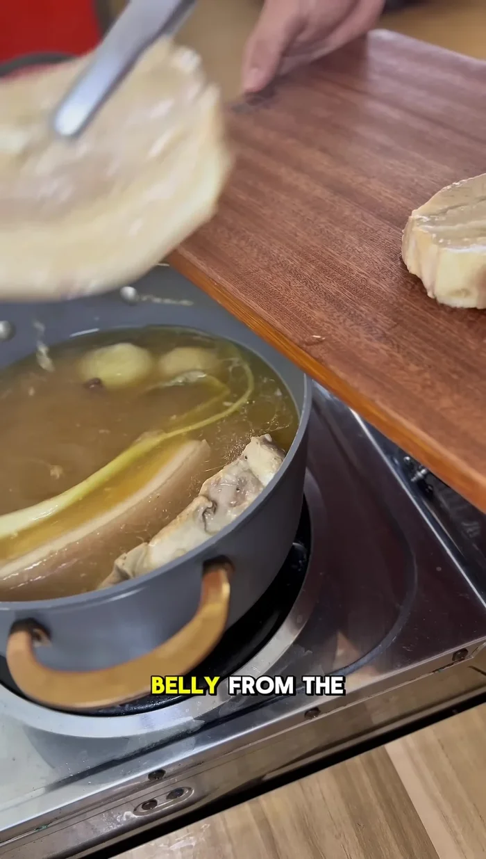 After 45 minutes, remove the pork belly from the pot and let it rest for 10 minutes. Then slice it thinly.