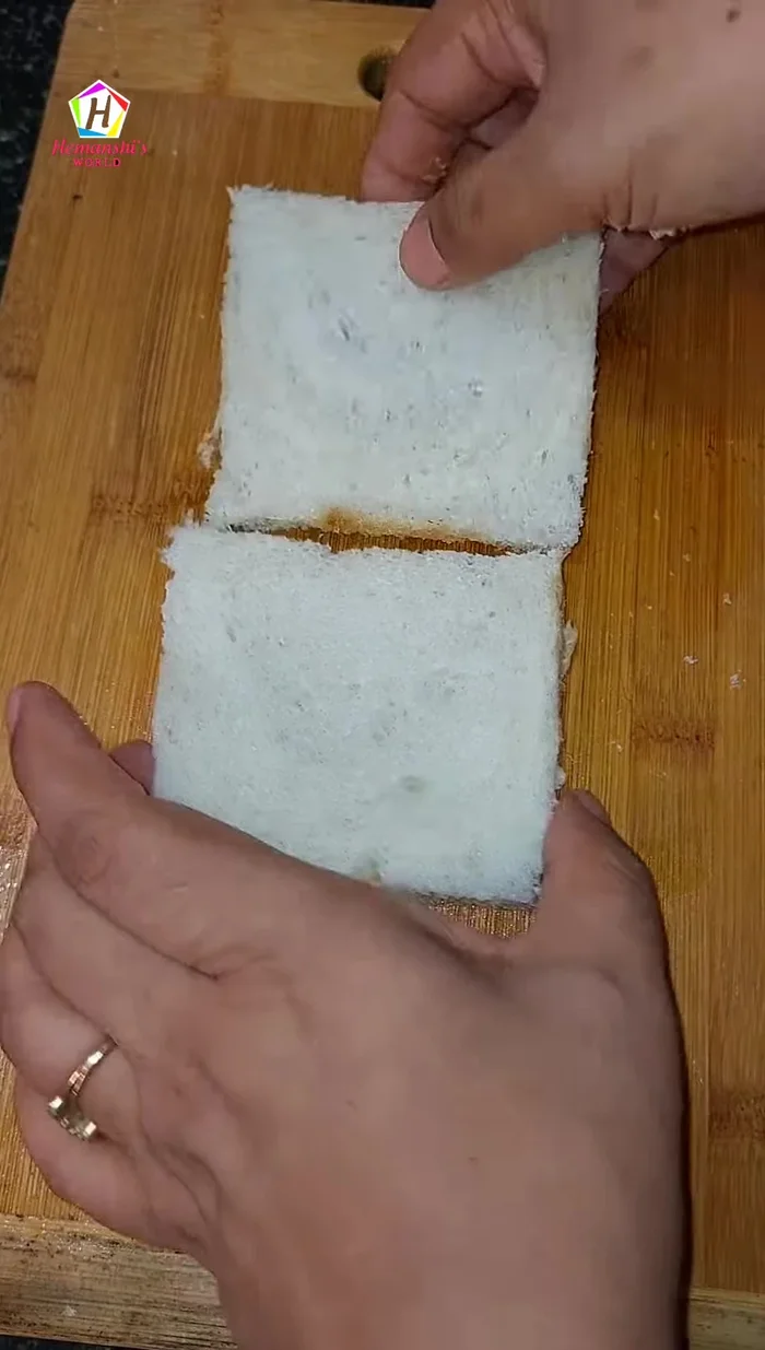Cut the crusts off the white bread slices.
