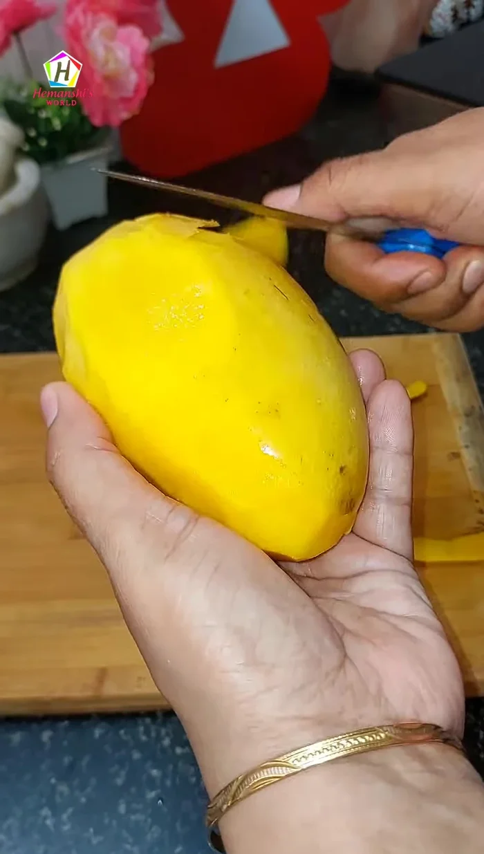 Peel and cut the ripe mango into chunks.