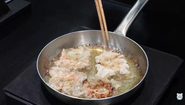 Fry the shrimp rolls in oil until cooked, turning occasionally.