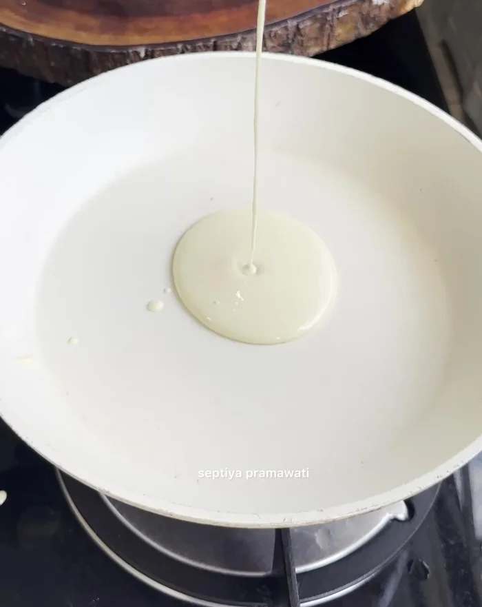 Heat Teflon pan. Pour a ladle of batter onto the hot pan and cook over low heat until browned.