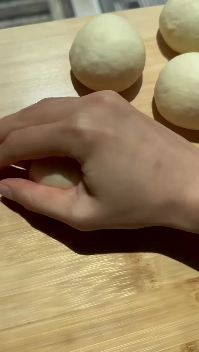 Roll the balls into teardrop shapes, approximately 6 inches long. Let them rest.