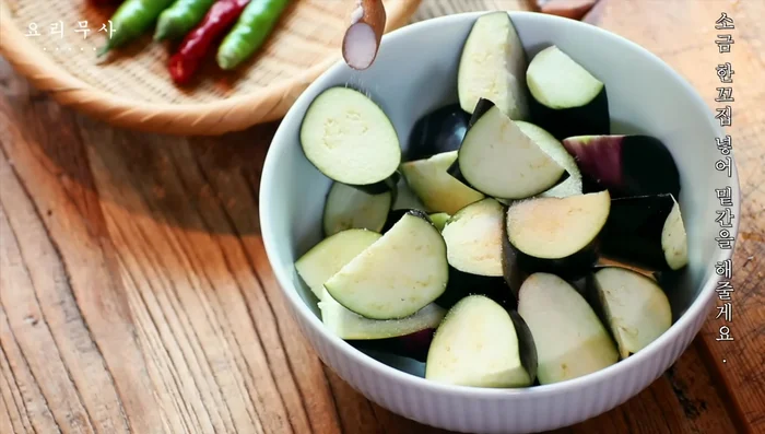 Season the eggplant with a pinch of salt.