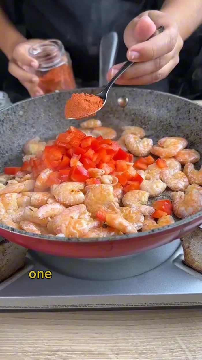 Add 1/4 chopped red bell pepper, 1 teaspoon paprika, 1 teaspoon salt, and 1/2 teaspoon black pepper. Sauté until well blended.