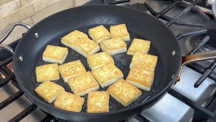 Stir-fry tofu briefly with a touch of soy sauce.