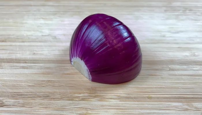 Cut half an onion into large strips. Separate onion layers.