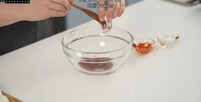 Prepare the ssamjang: In a bowl, mix gochujang, doenjang, red pepper powder, minced garlic, sugar, pepper, sesame oil, sesame seeds, and water.