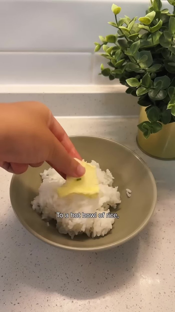 Add butter to a hot bowl of rice and mix in the fried eggs. (Kjangab - Soy Sauce Egg Rice)