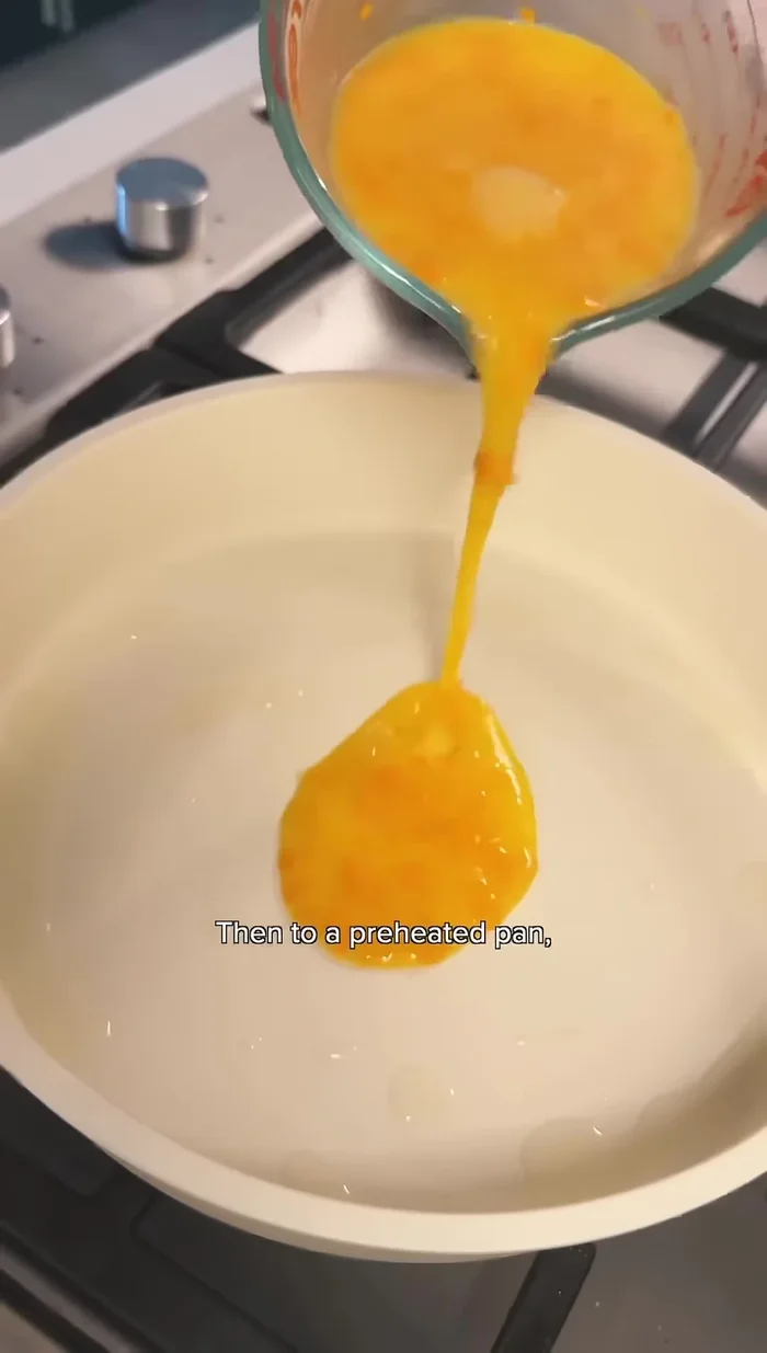 Pour egg mixture into a preheated pan with oil.
