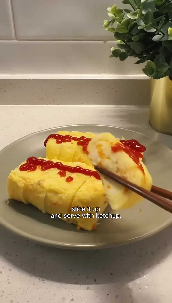 Slice the rolled omelette and serve with ketchup.