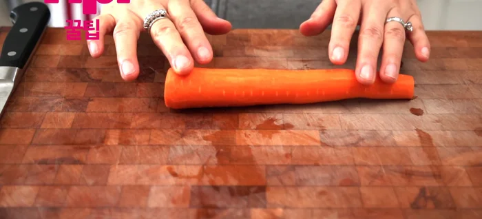 Cut carrots into thin strips. Cut the bottom of the carrot to stabilize it before slicing.