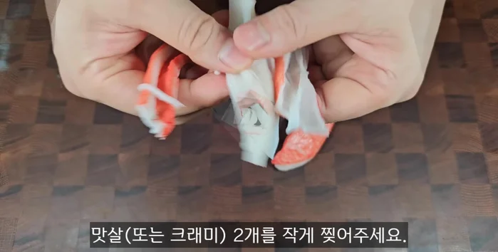 Tear two meatballs into small pieces.