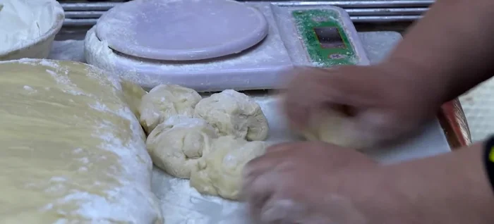 Portion the dough into small pieces. Roll each piece into a ball, flatten slightly and place the prepared filling in the center.