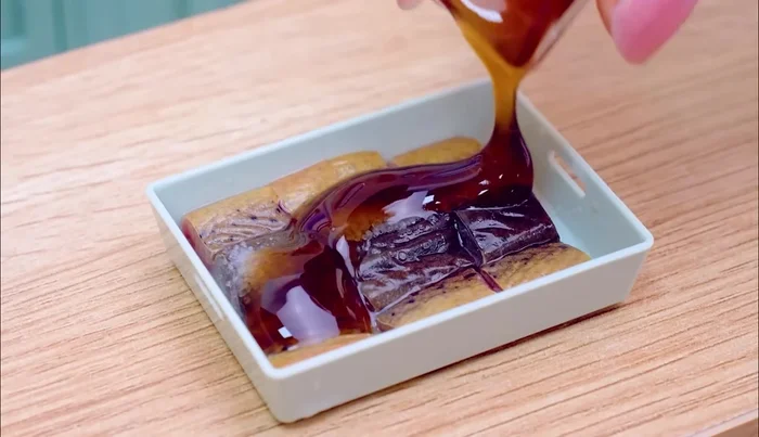 Prepare the stuffed fish: Season with salt, ununagi sauce, and lemon.