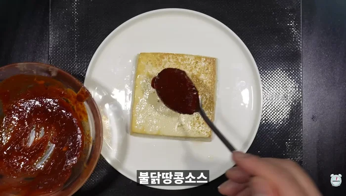 Air Fryer Tofu: Spread buldak-dangkong sauce on tofu. Bake in an air fryer. Sprinkle with green onions.
