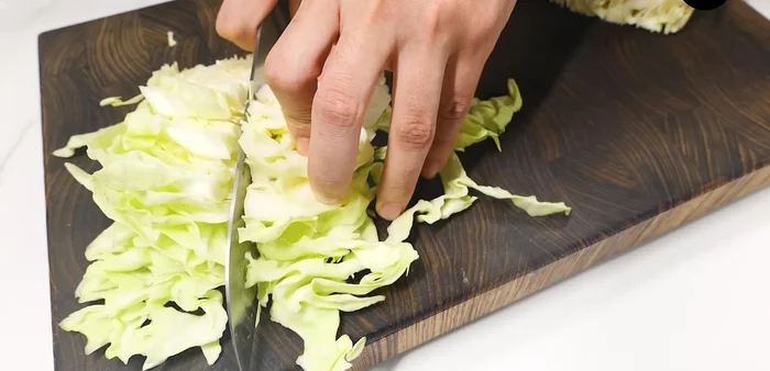 Prepare cabbage: cut into 1cm thick pieces. Lightly coat pan, add cabbage, season with salt and pepper. Stir-fry until wilted and mushy.