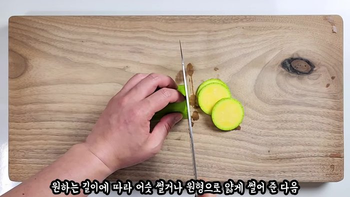 Slice zucchini thinly into circles or strips. If needed, use a cleaver.