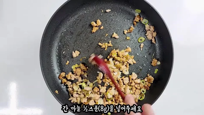 Add the pork mixture to the soy sauce mixture, break it up, and stir-fry until almost cooked. Add green chili peppers.