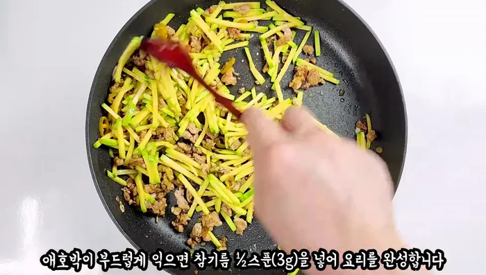 Add sesame oil to the zucchini and finish cooking.